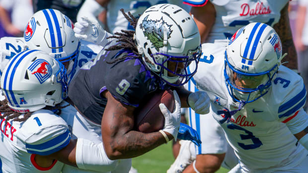 SMU defenders Brandon Crossley andCharles Woods close in on a TCU receiver Saturday